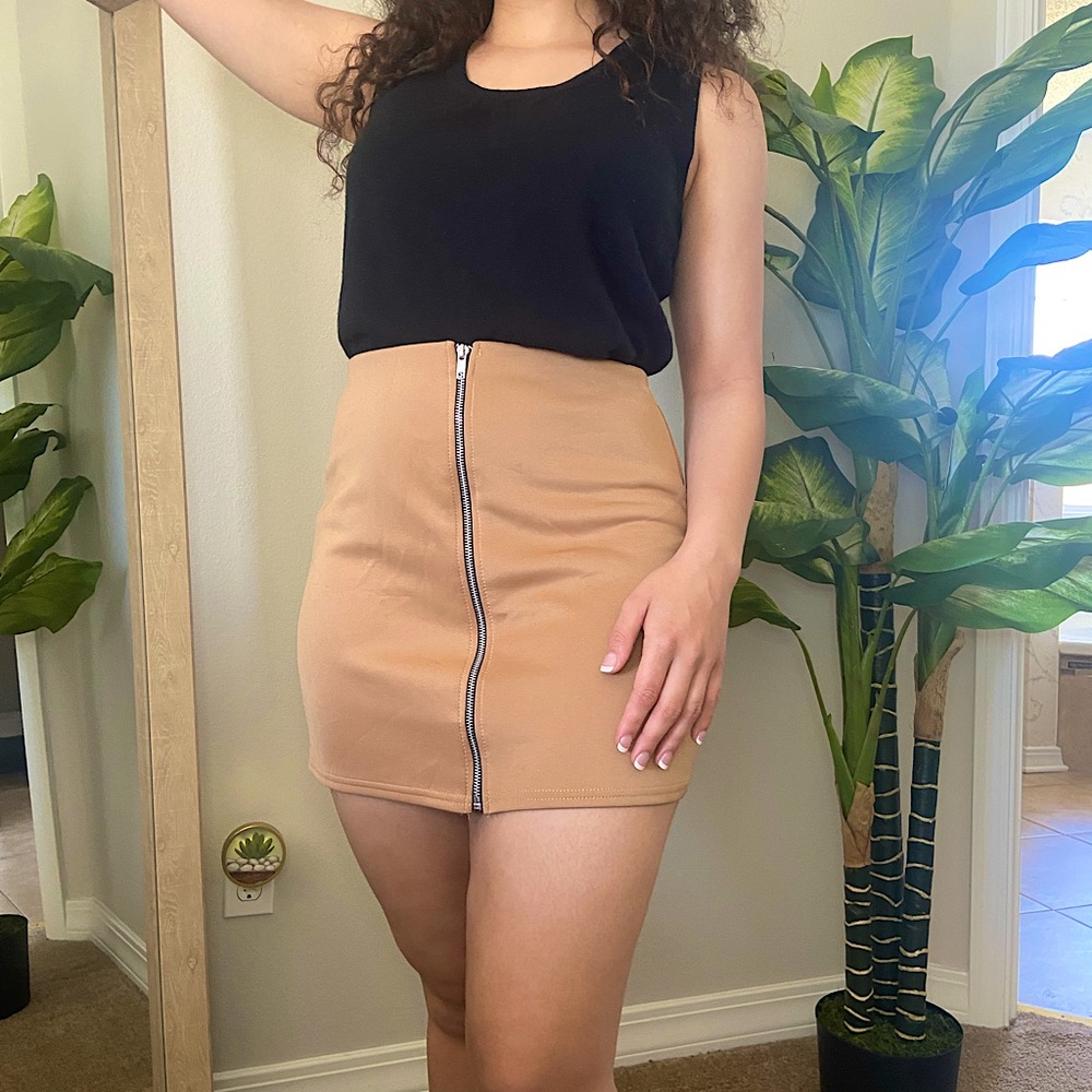 Tan mini skirt with a front black and silver zipper